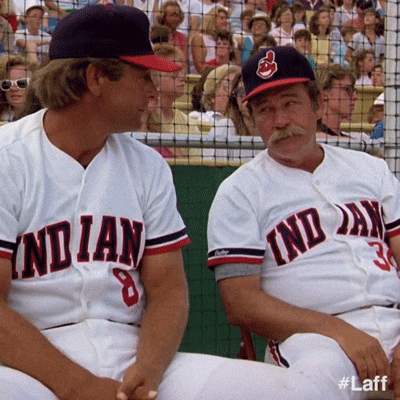A scene from the movie Major League where the coach are just shrugging and giving up.